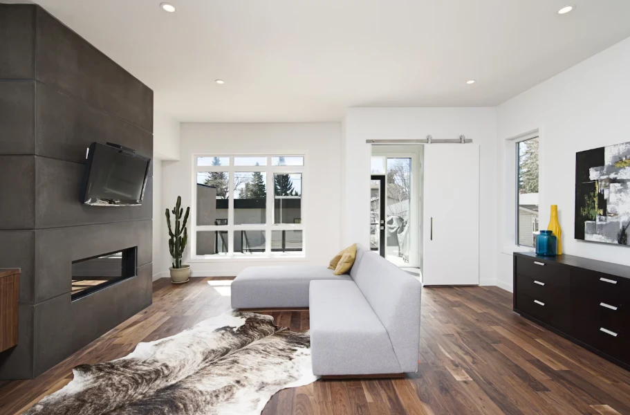 Finished room addition with modern fireplace and hardwood floors reflecting room addition cost in Ventura County