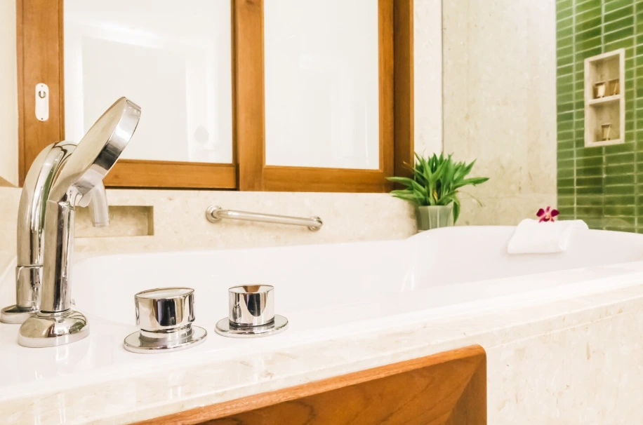 New bathtub faucet and marble surround installation showing kitchen and bath remodel cost in Conejo Valley