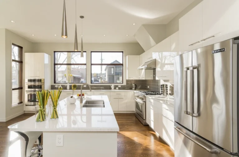 Spacious kitchen renovation with white cabinets and quartz countertops highlighting kitchen remodel cost in Ventura County