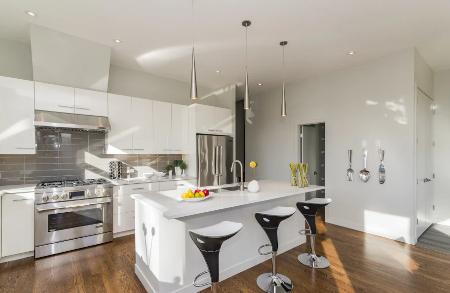 White kitchen remodel with quartz island and stainless steel appliances reflecting kitchen remodel cost in Ventura County