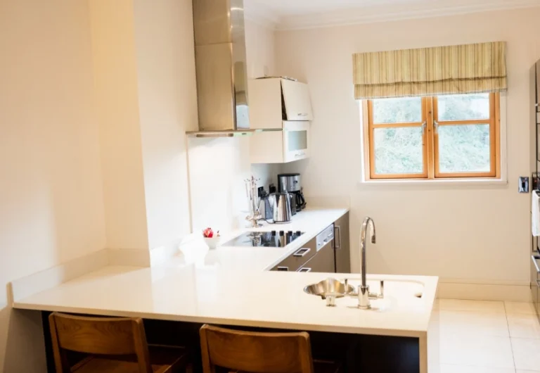 Compact peninsula kitchen with a window and counter seating showing small kitchen remodel ideas