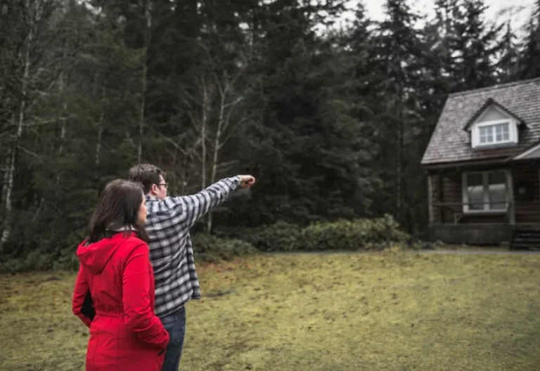 Couple reviewing backyard space and setbacks for a detached accessory dwelling unit