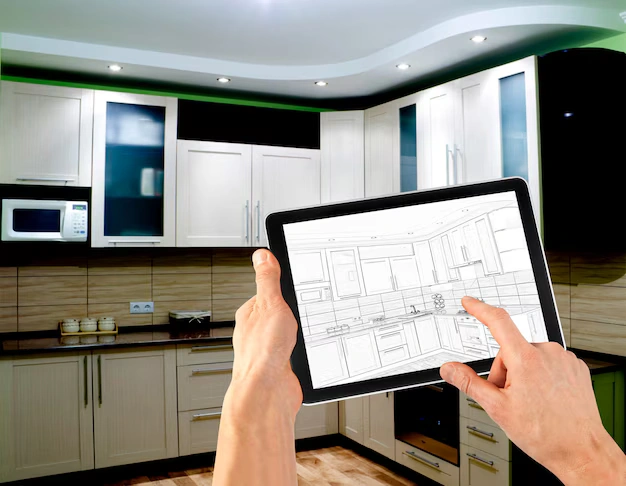 Contractor on a phone call with tile and paint samples on a kitchen counter