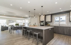 Open concept kitchen remodel with a large quartz island and dark wood cabinetry